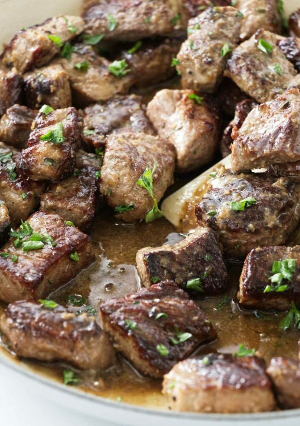 Garlic steak bites in a skillet.