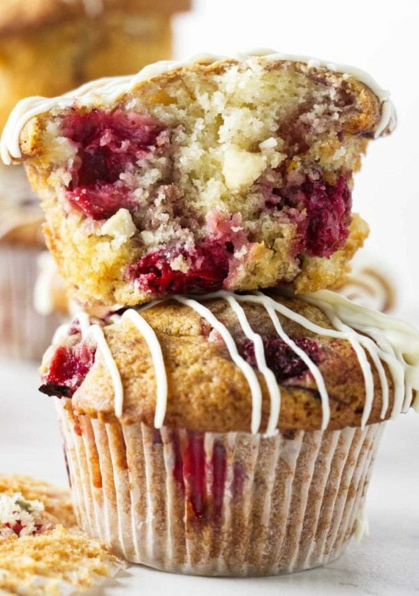 Two strawberry white chocolate muffins stacked on top of each other.