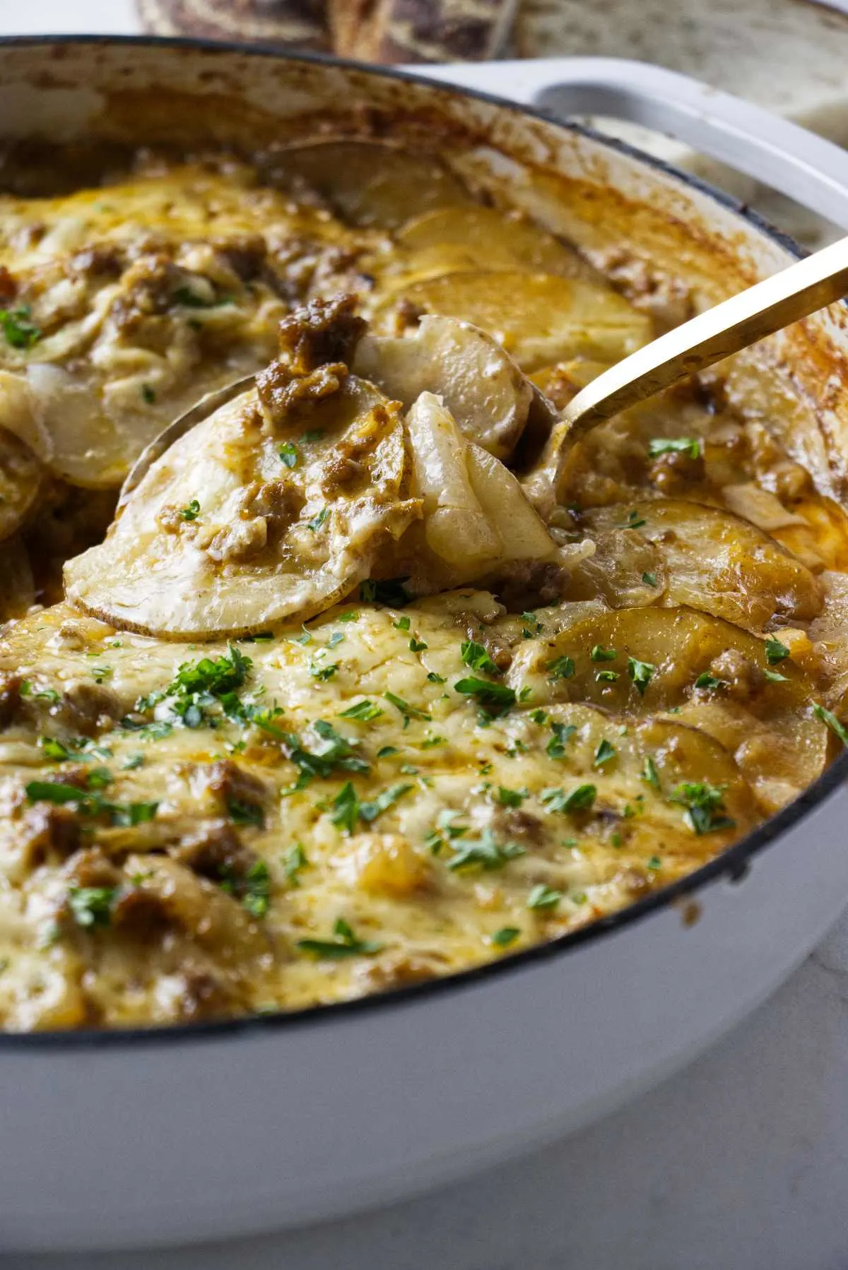 Scooping a serving of hamburger potato skillet bake.