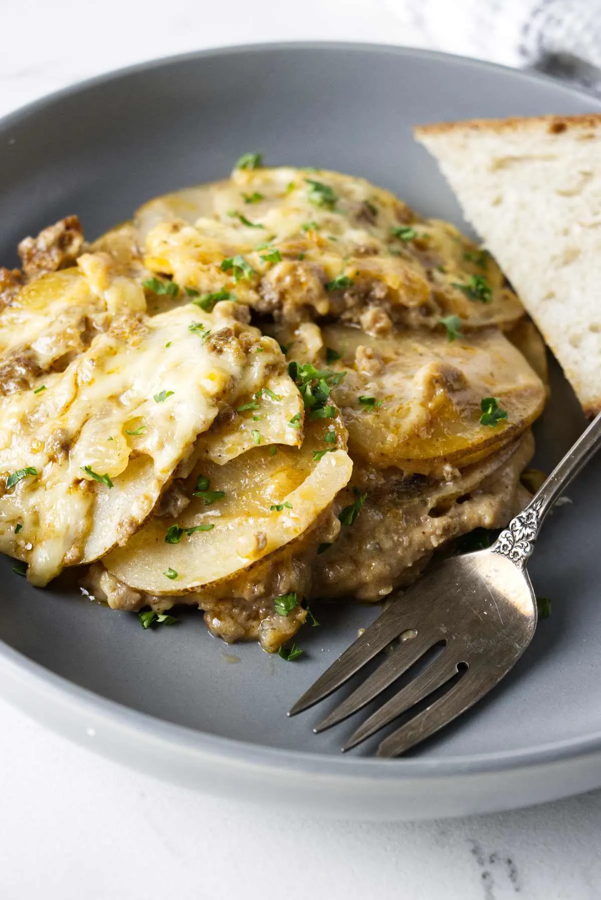 A serving of ground beef and potato casserole on a plate.