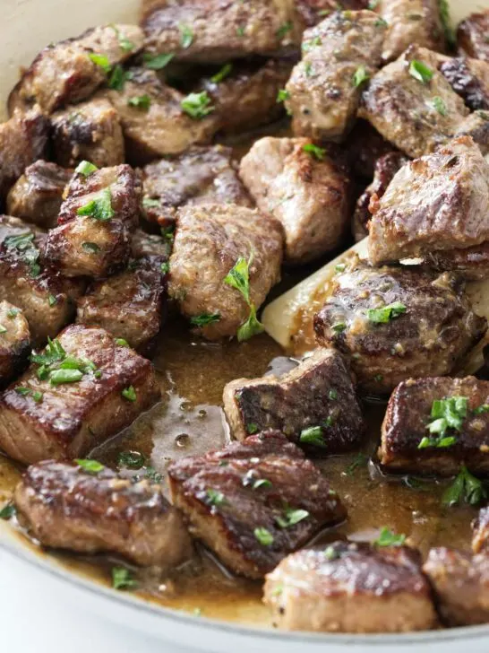 Garlic steak bites in a skillet.