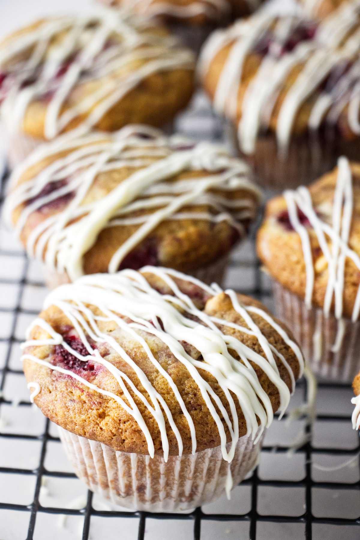 Strawberry white chocolate muffins drizzled with white chocolate.