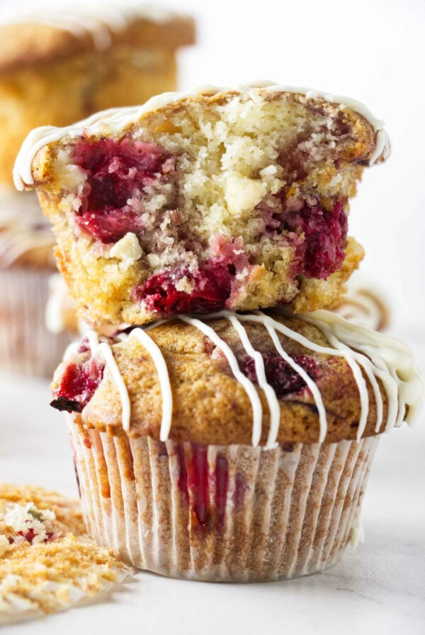 Two strawberry white chocolate muffins stacked on top of each other.