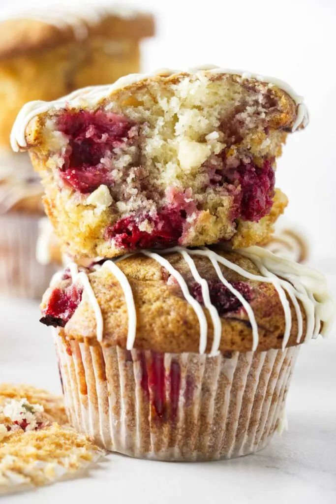 Two strawberry white chocolate muffins stacked on top of each other.