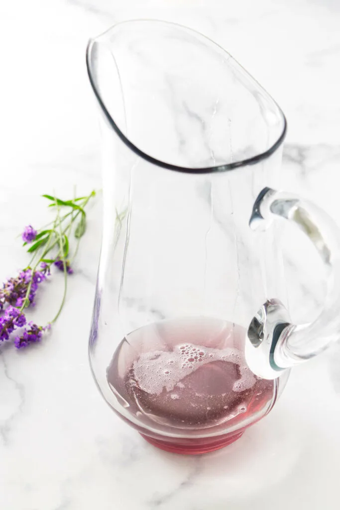 Lavender syrup in a pitcher.