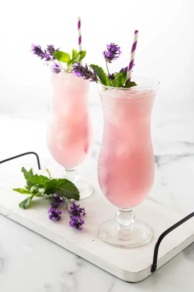 Two glasses of lavender lemonade on a serving tray.