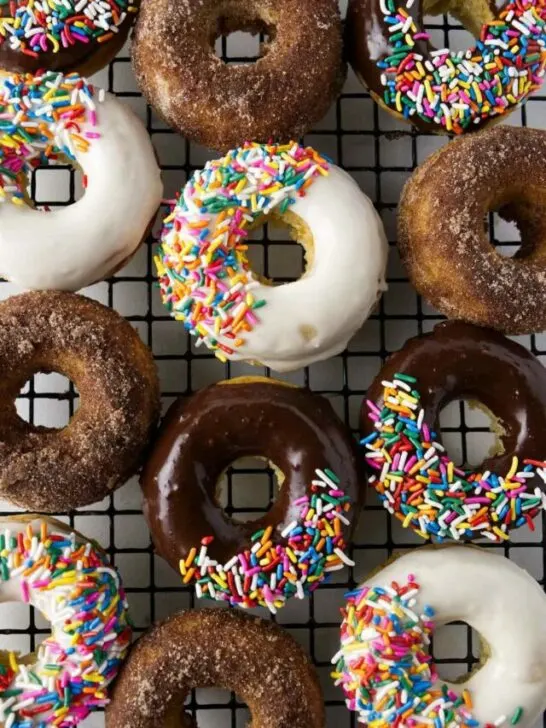 chocolate and vanilla glazed donuts with colorful sprinkles.