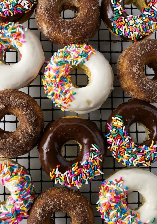 chocolate and vanilla glazed donuts with colorful sprinkles.