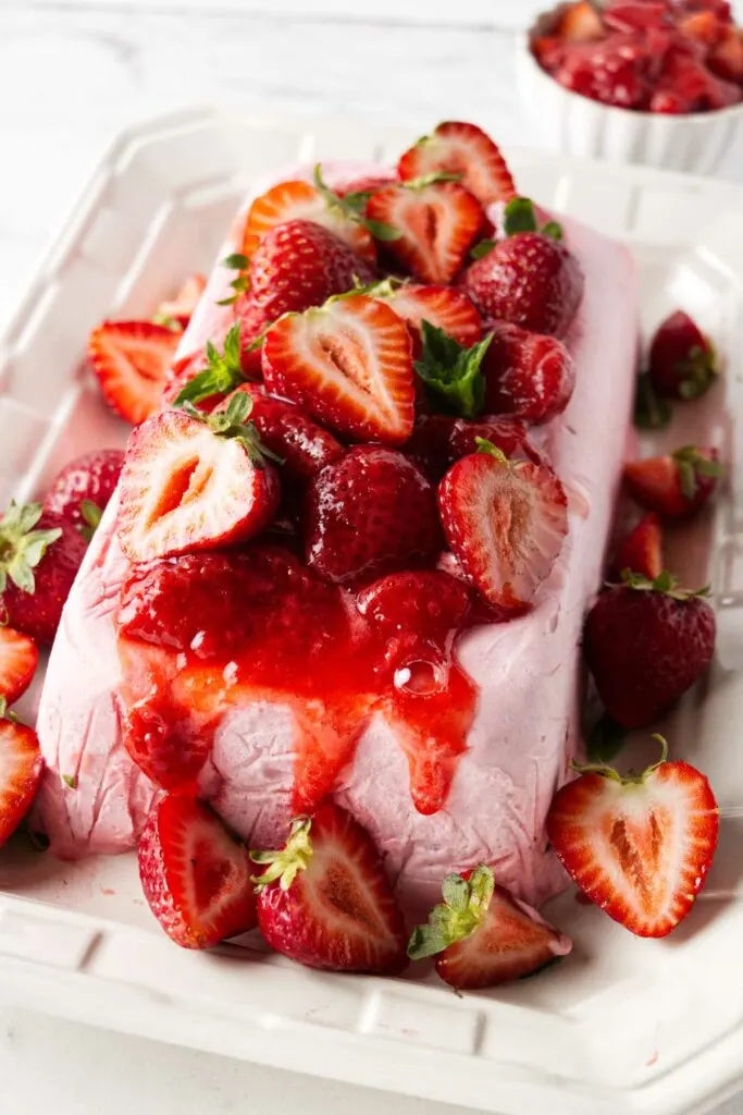 Strawberries on top of a large serving of semifreddo.