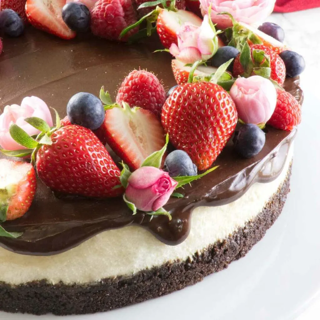 Cheesecake with chocolate ganache and berries.