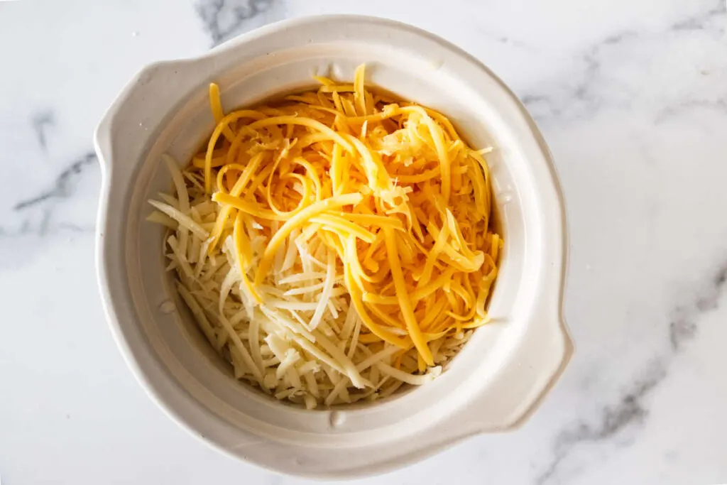 Two kinds of cheese in a small crock pot.