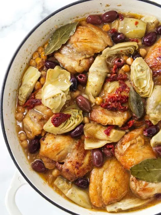Pot with chicken, artichokes, olives and garbanzo beans ready to be served.