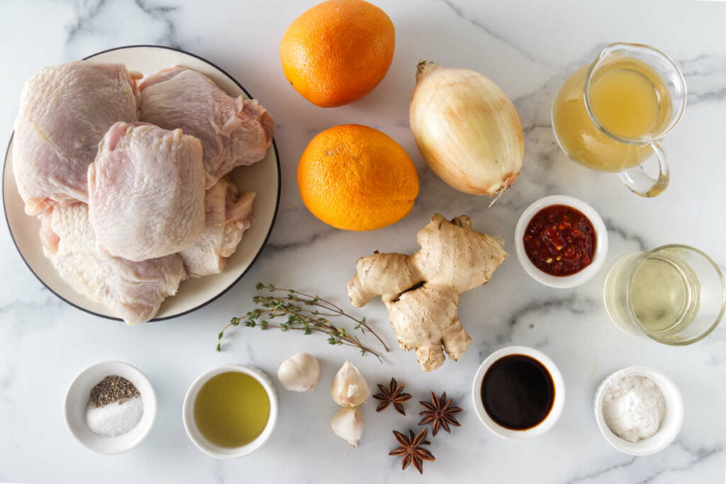 Ingredients for chicken with star anise orange sauce: chicken thighs, oranges, star anise, onions, garlic, ginger, chile sauce, broth, wine, soy sauce, salt, pepper, and oil.