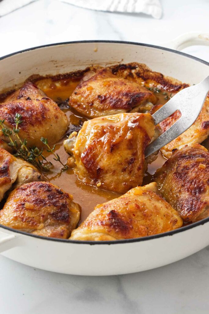 A skillet filled with chicken and star anise sauce.