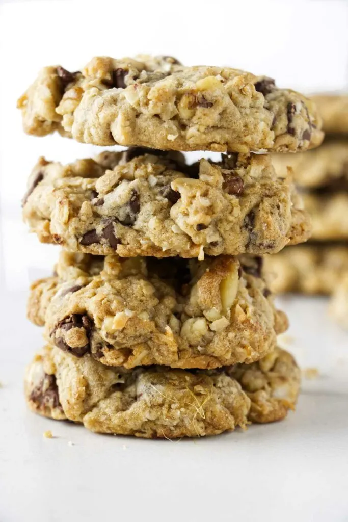 Four thick cookies loaded with oats and nuts stacked on top of each other.