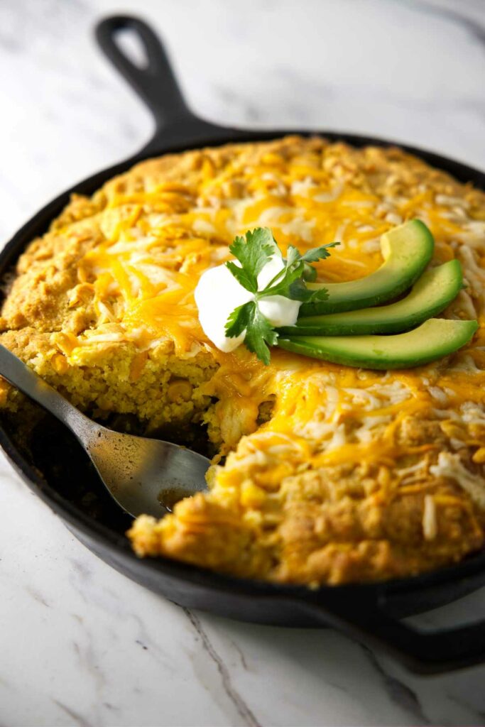 A cornbread topped tamale pie in a cast iron skillet.