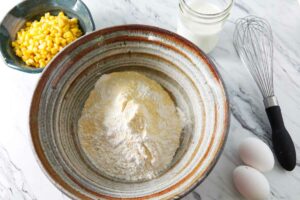 Making a cornbread topping in a mixing bowl.