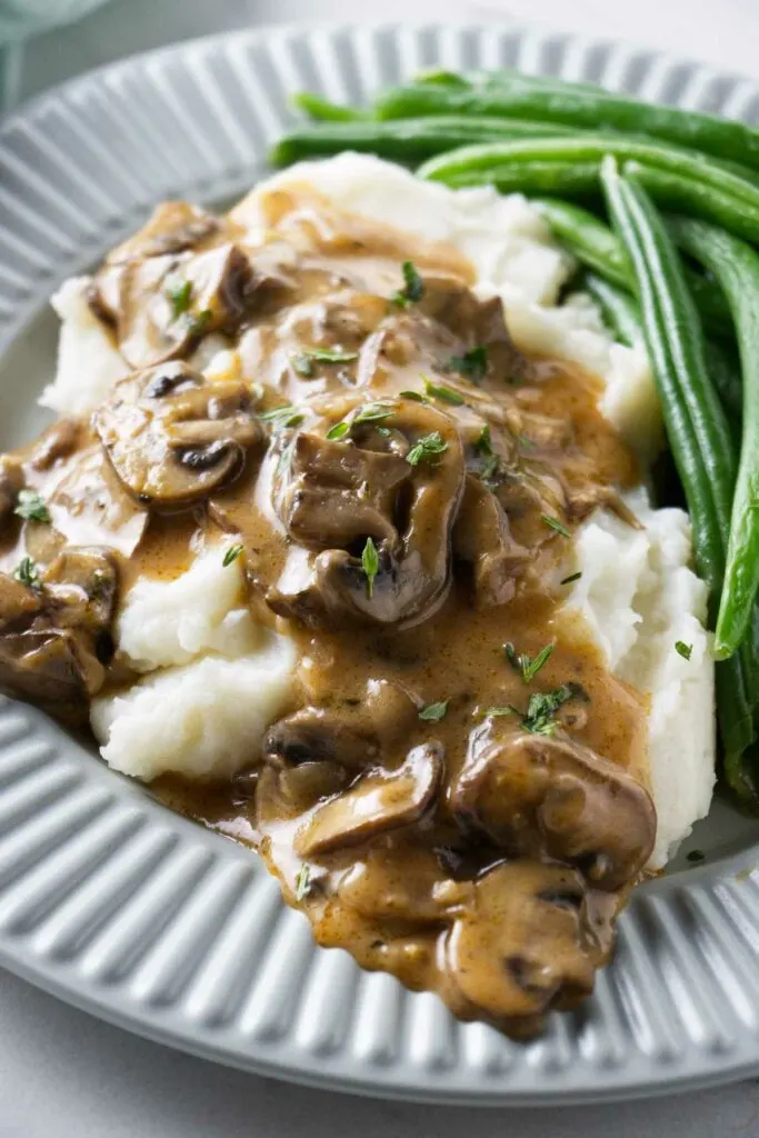 Marsala sauce on top of a serving of mashed potatoes.