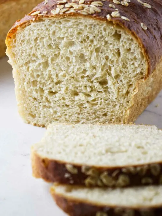 A loaf of oatmeal bread sliced in half.