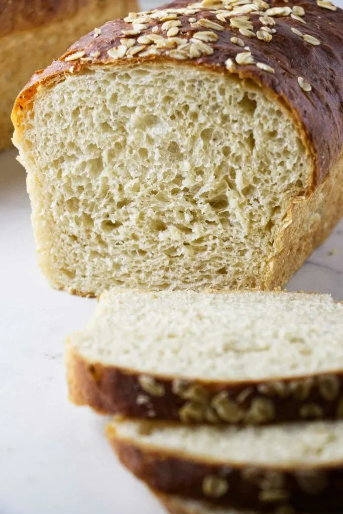 A loaf of oatmeal bread sliced in half.