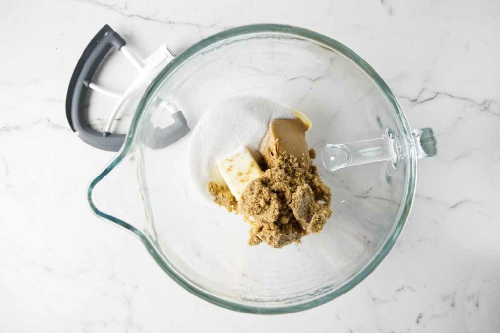 Butter, peanut butter, brown sugar, and granulated sugar in a mixing bowl.