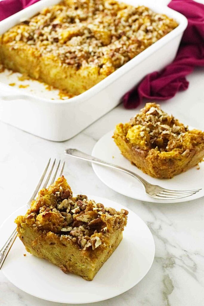 casserole with pecan crusted topping with two servings cut on saucers.
