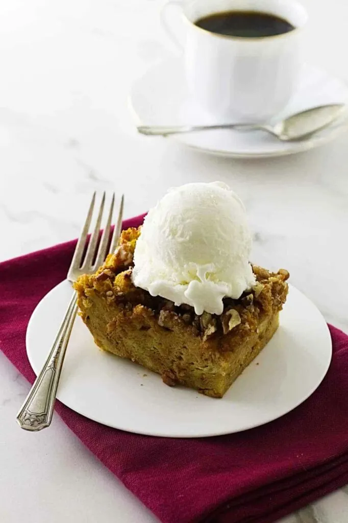 dessert on a saucer with vanilla ice cream on top.