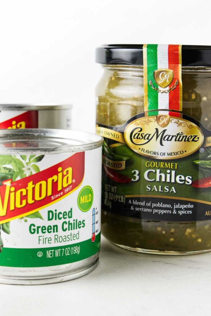 Two cans of diced green chiles and a jar of green chile salsa.