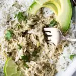 A bowl of shredded chicken cooked in the slow cooker with green chiles.