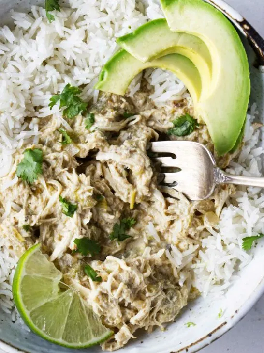 A bowl of shredded chicken cooked in the slow cooker with green chiles.