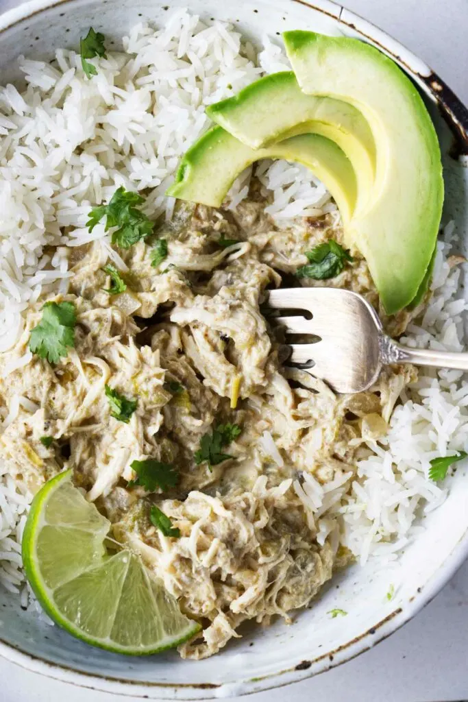 A bowl of shredded chicken cooked in the slow cooker with green chiles.