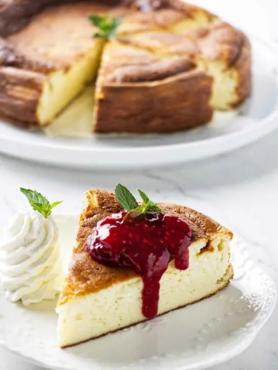 A slice of creamy yogurt cake behind a plate with more cake.