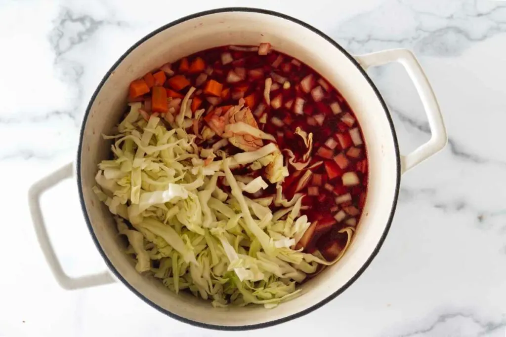 A soup pot with cabbage and vegetables.