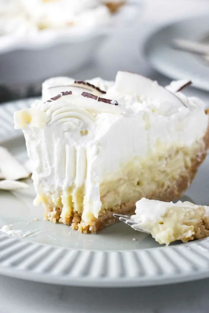 A partially eaten slice of creamy coconut pie.