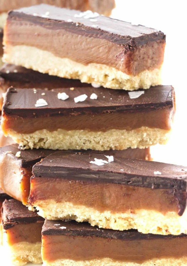 A stack of cookie bars with salt flakes sprinkled on top.