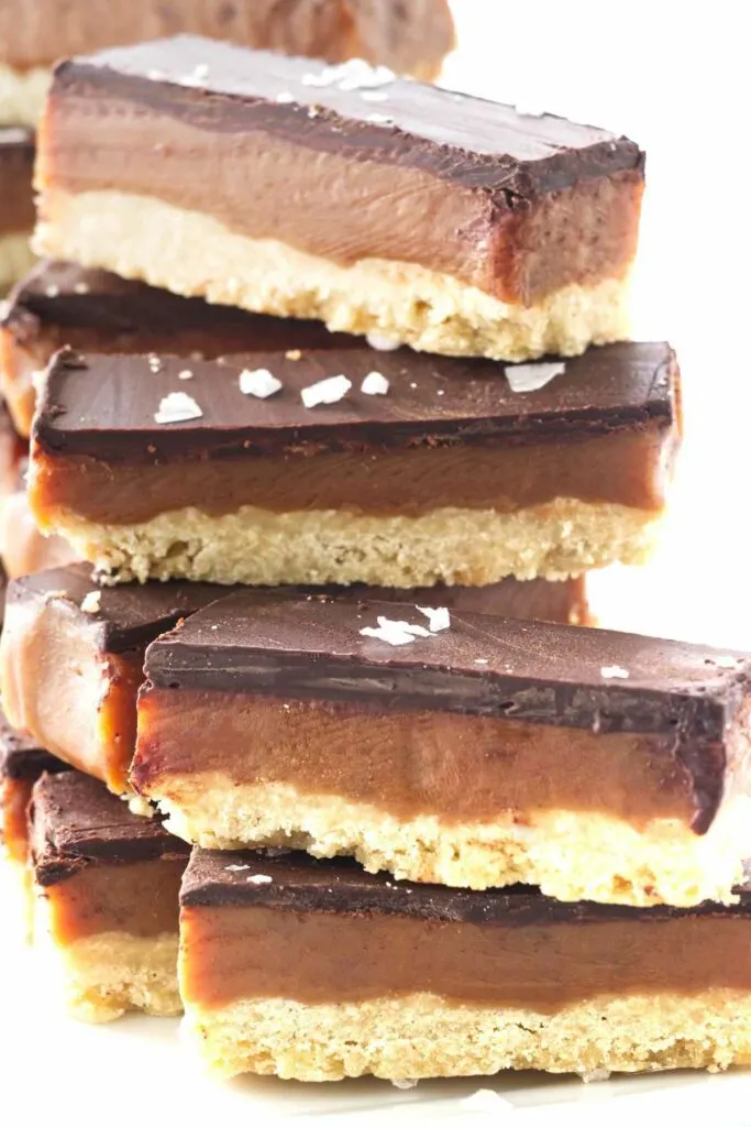 A stack of cookie bars with salt flakes sprinkled on top.