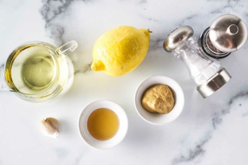 Ingredients for honey lemon vinaigrette: Oil, lemon, garlic honey, mustard, salt and pepper.