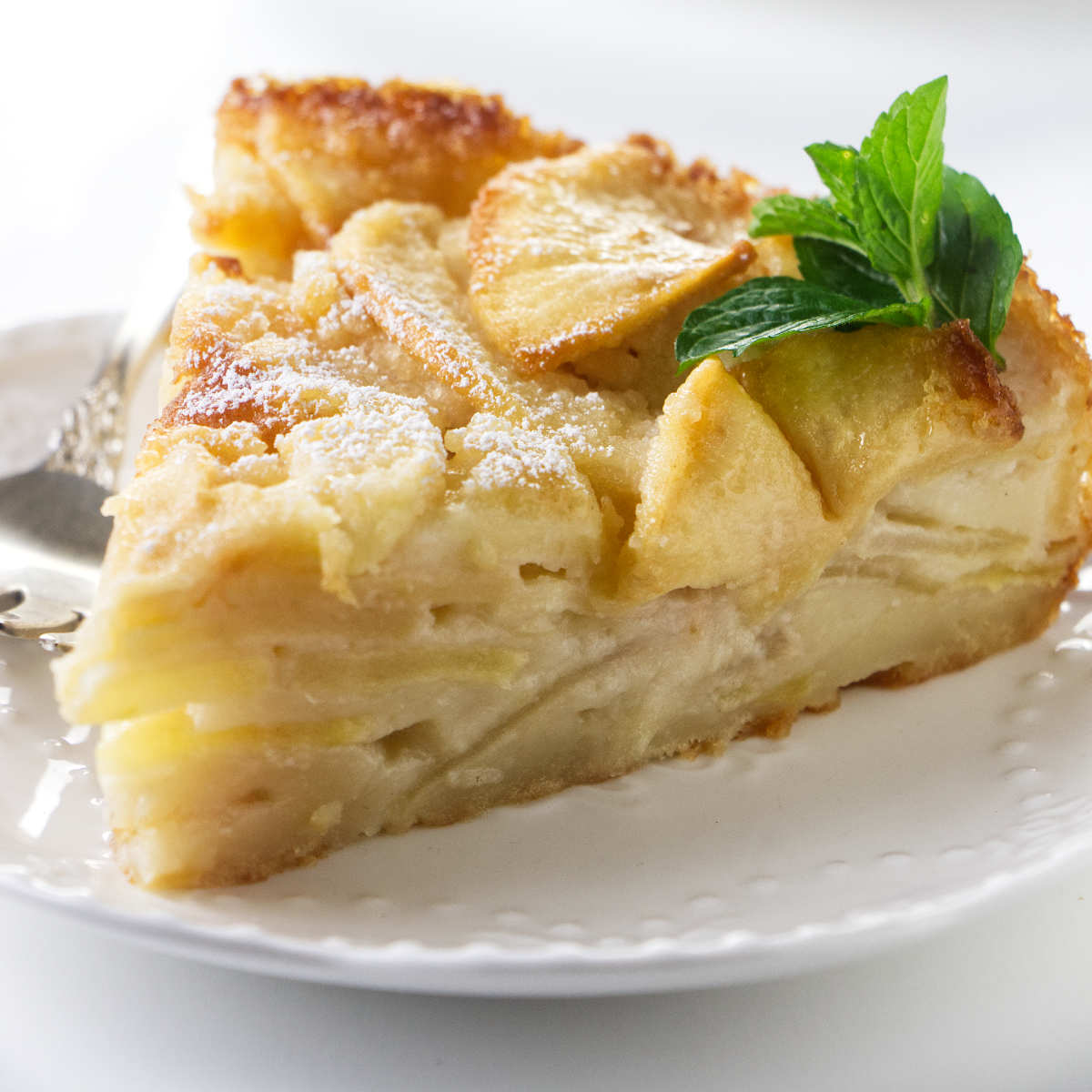 A slice of apple cake on a plate.