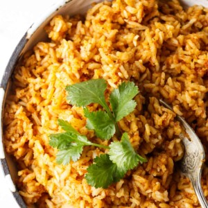 Mexican red rice in a serving dish with a fork.