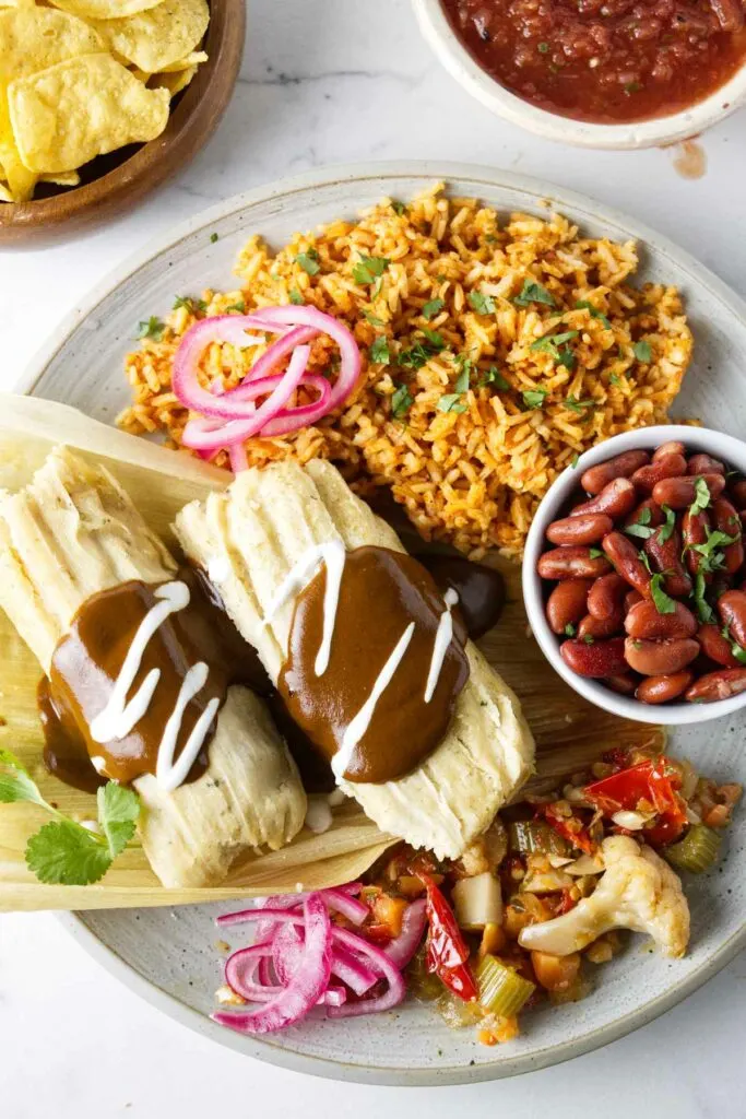 https://savorthebest.com/wp-content/uploads/2023/10/red-rice-with-beans-and-tamales_5418-1-683x1024.jpg.webp