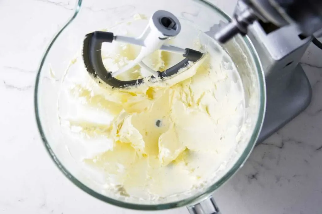 Whipping butter in a mixing bowl.