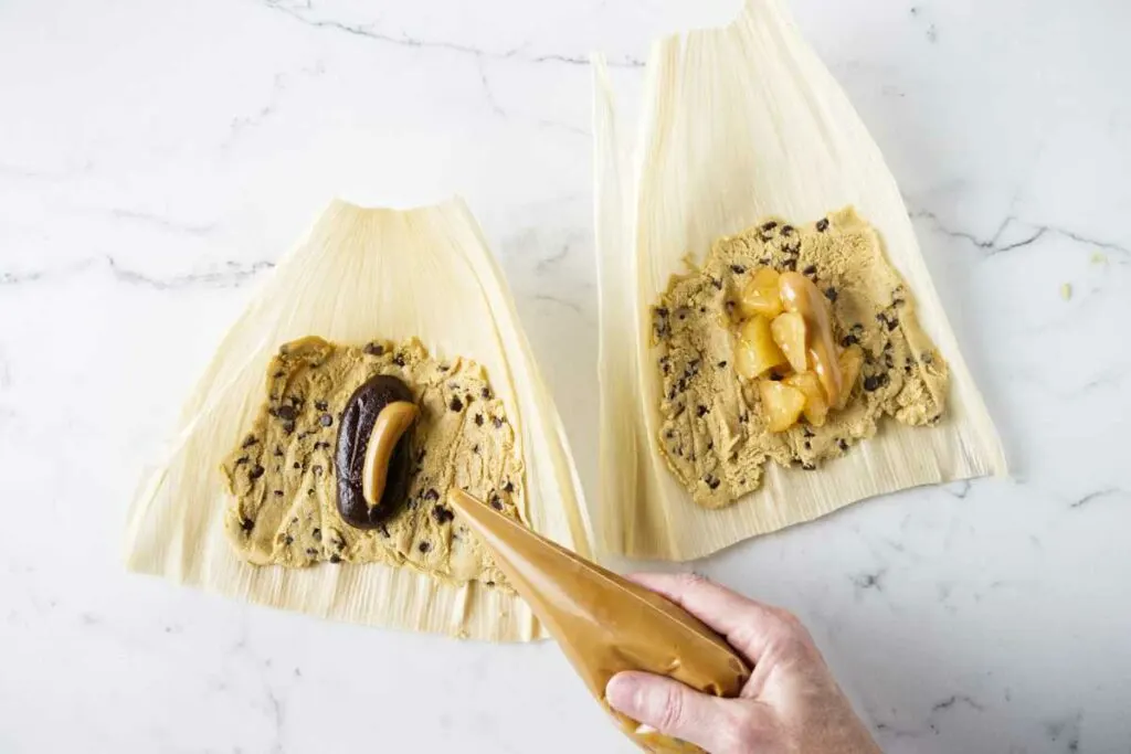 Adding sweet fillings to tamales.