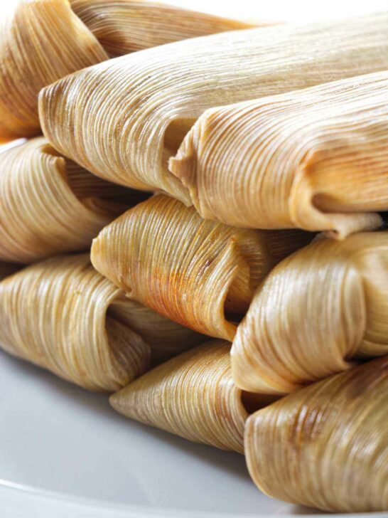 Several tamales wrapped in corn husk.