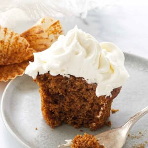 A serving of pumpkin cupcake with a bite on a fork.