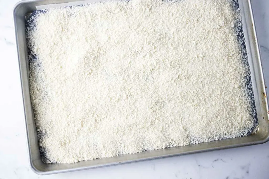 Panko spread out on a baking sheet.