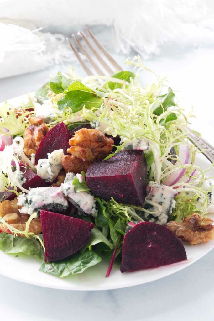 A beet salad with blue cheese and walnuts.