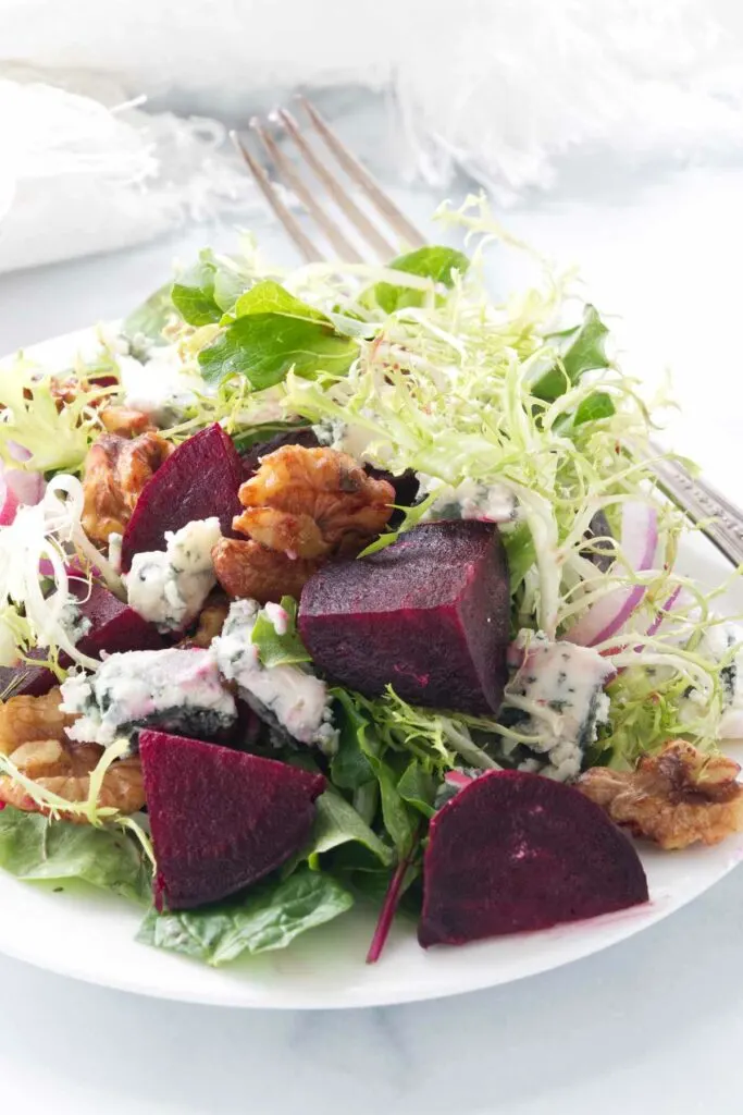 A beet salad with blue cheese and walnuts.