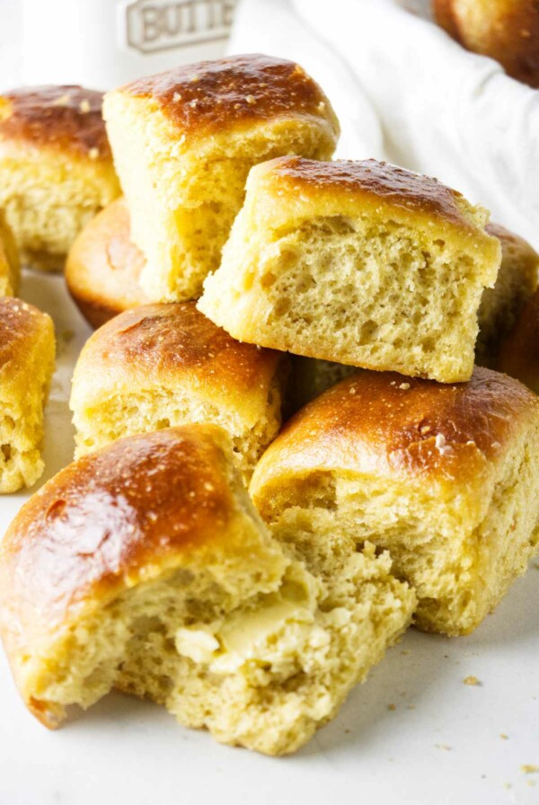 Einkorn dinner rolls stacked on a countertop.