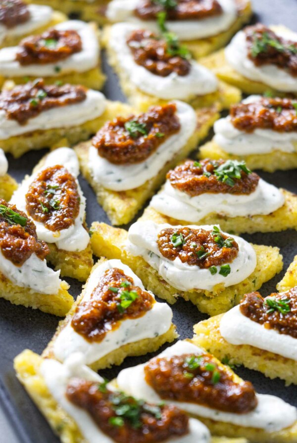 Several polenta appetizer bites on a serving platter.