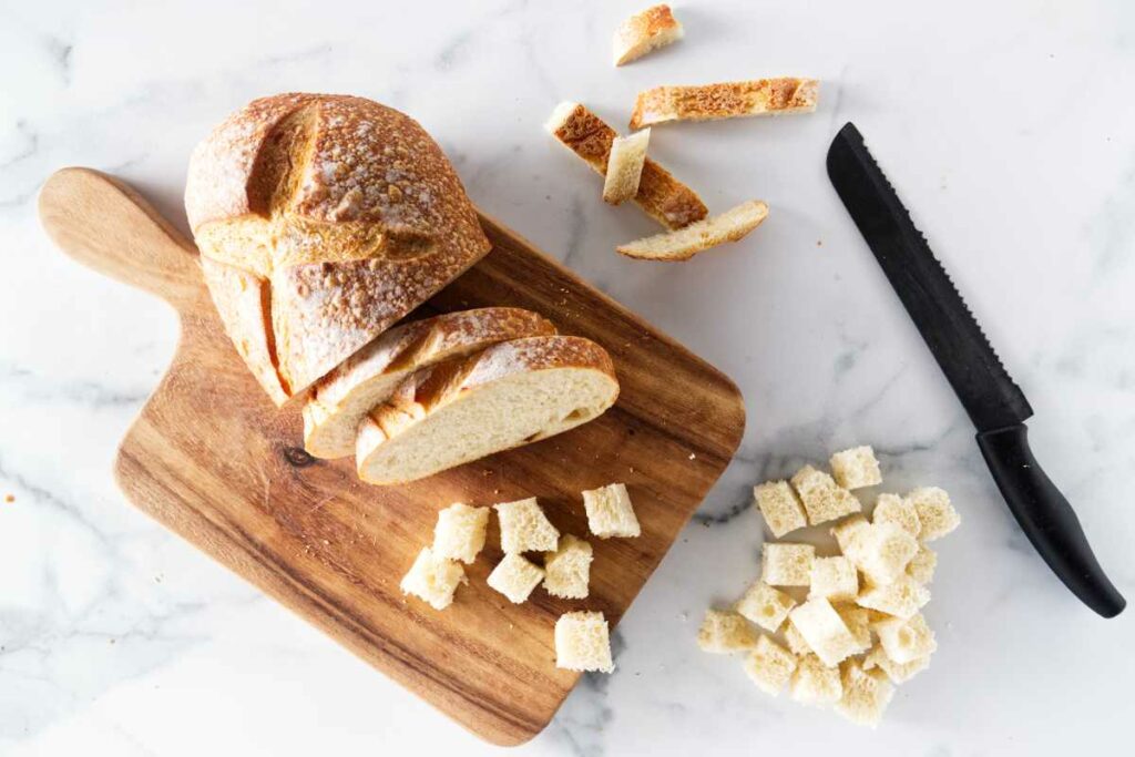 Slicing a loaf of bread to make croutons.
